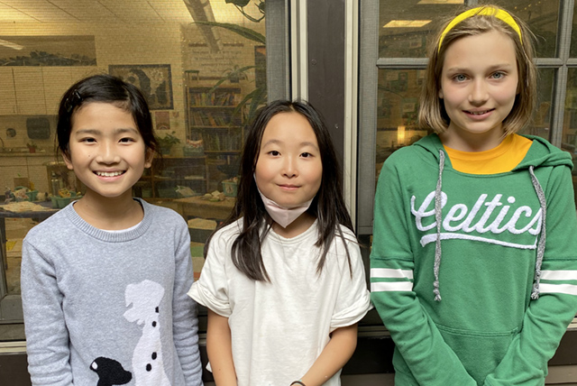 A drawing by a pre-k student of two hearts and a hand