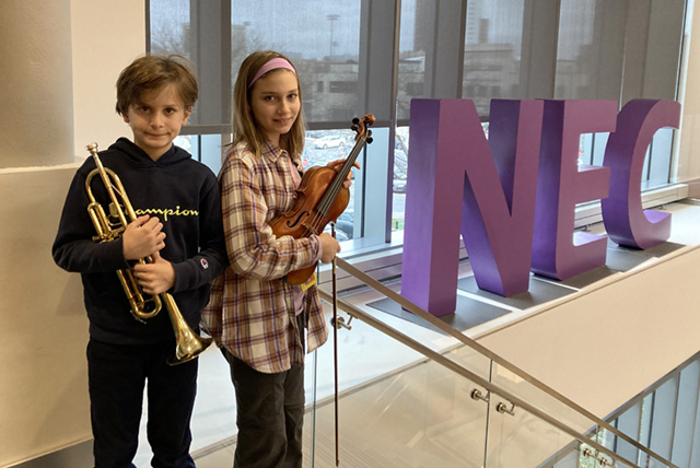 A drawing by a pre-k student of two hearts and a hand