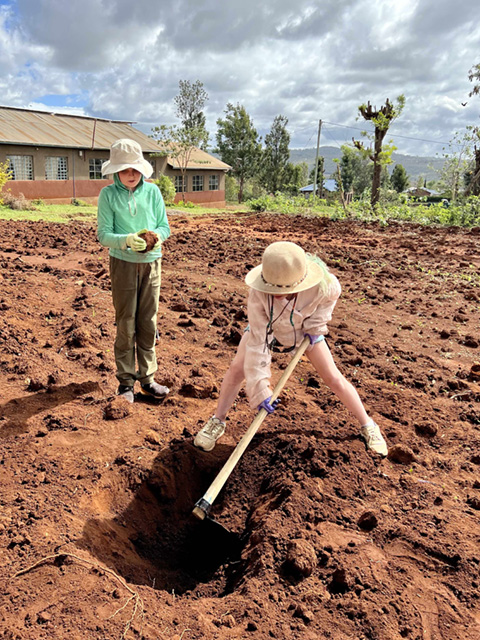 A drawing by a pre-k student of two hearts and a hand